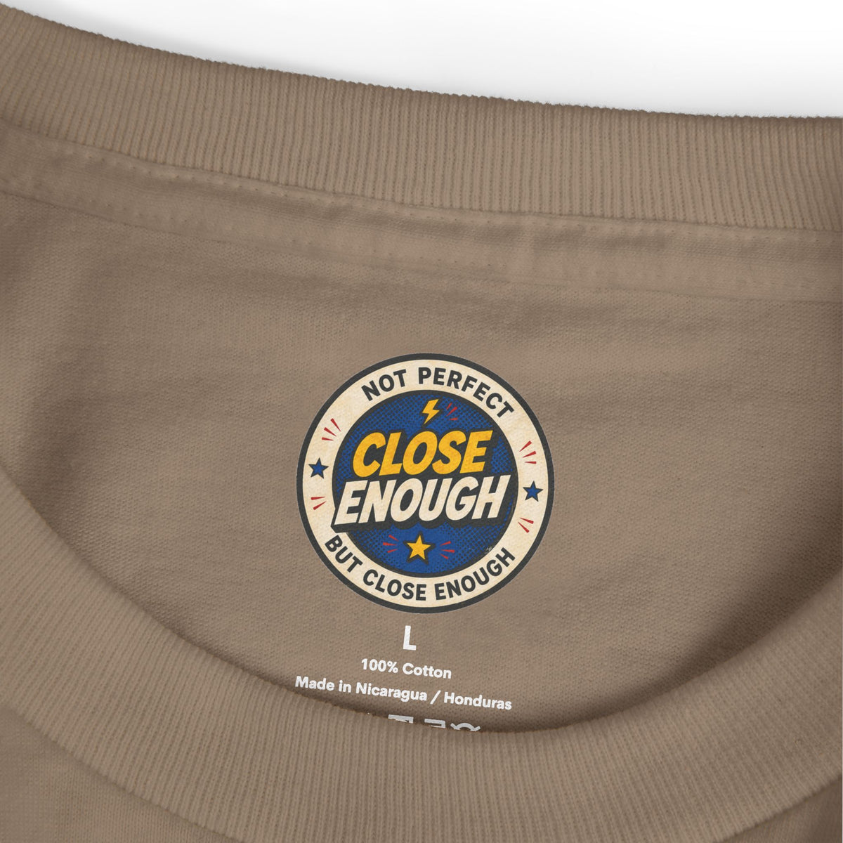 Close Enough printed neck label on Faded Brown garment-dyed tee