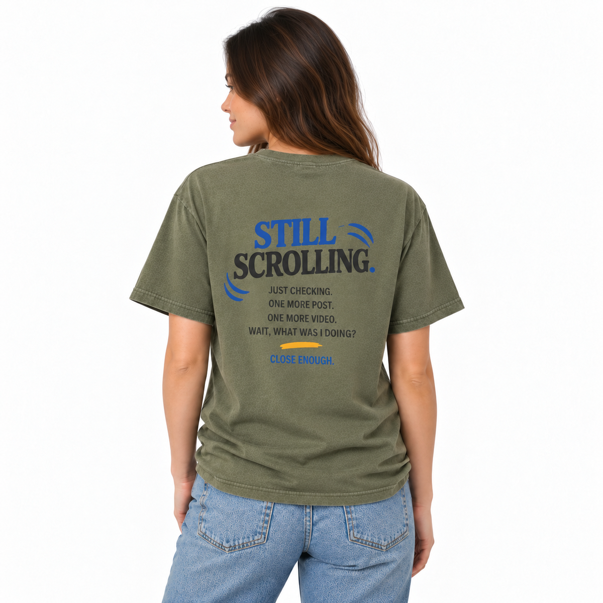 Female model wearing the Close Enough One Quick Look Tee in Faded Army, back view with Still Scrolling graphic