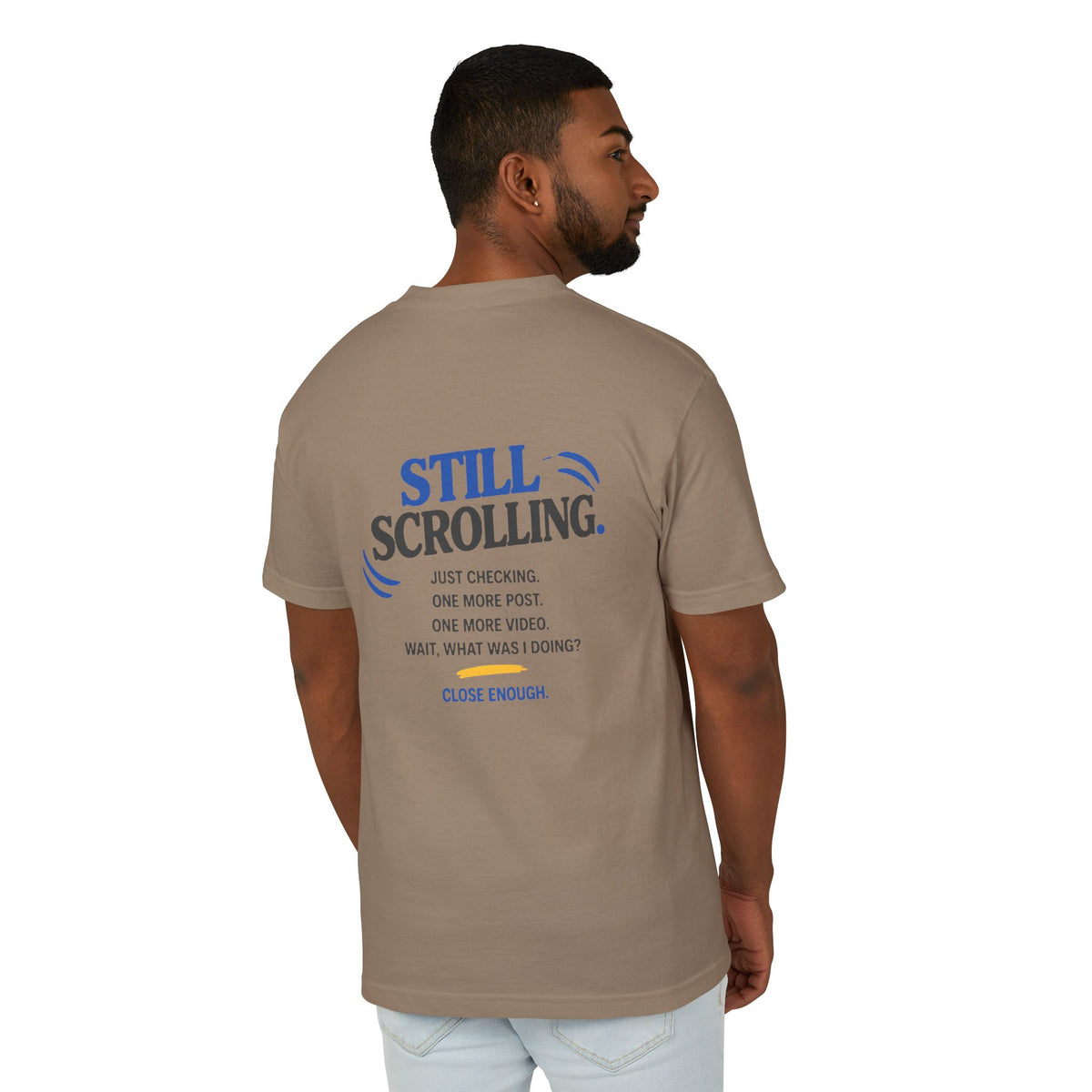 Male model wearing the Close Enough One Quick Look Tee in Faded Brown, back view with Still Scrolling graphic