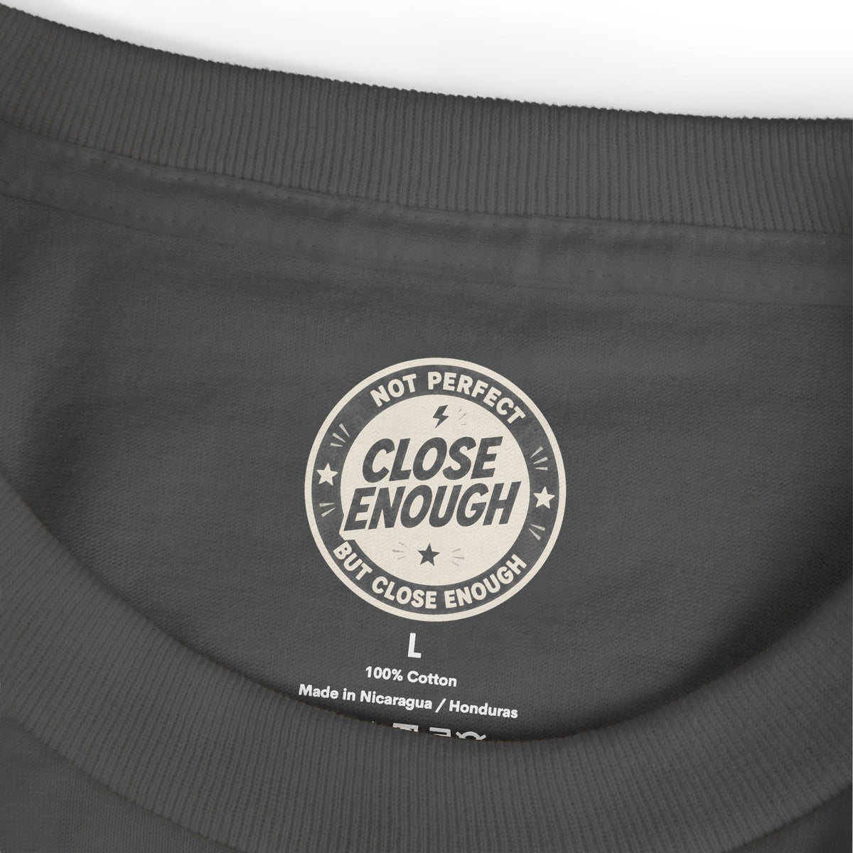 CLOSE ENOUGH neck label on the FOGCUS tee in Faded Black
