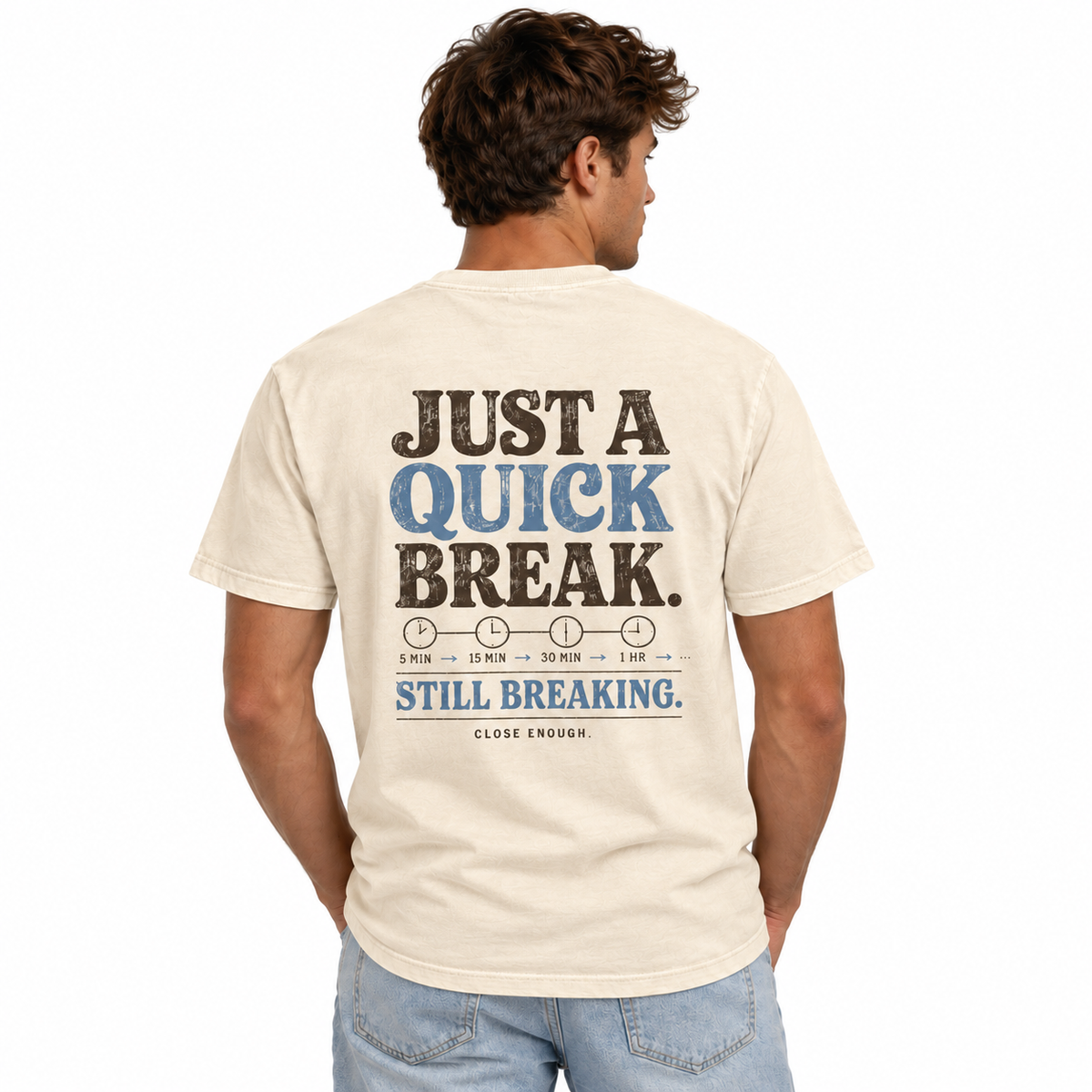 Man wearing the BE RIGHT BACK cream tee showing back artwork