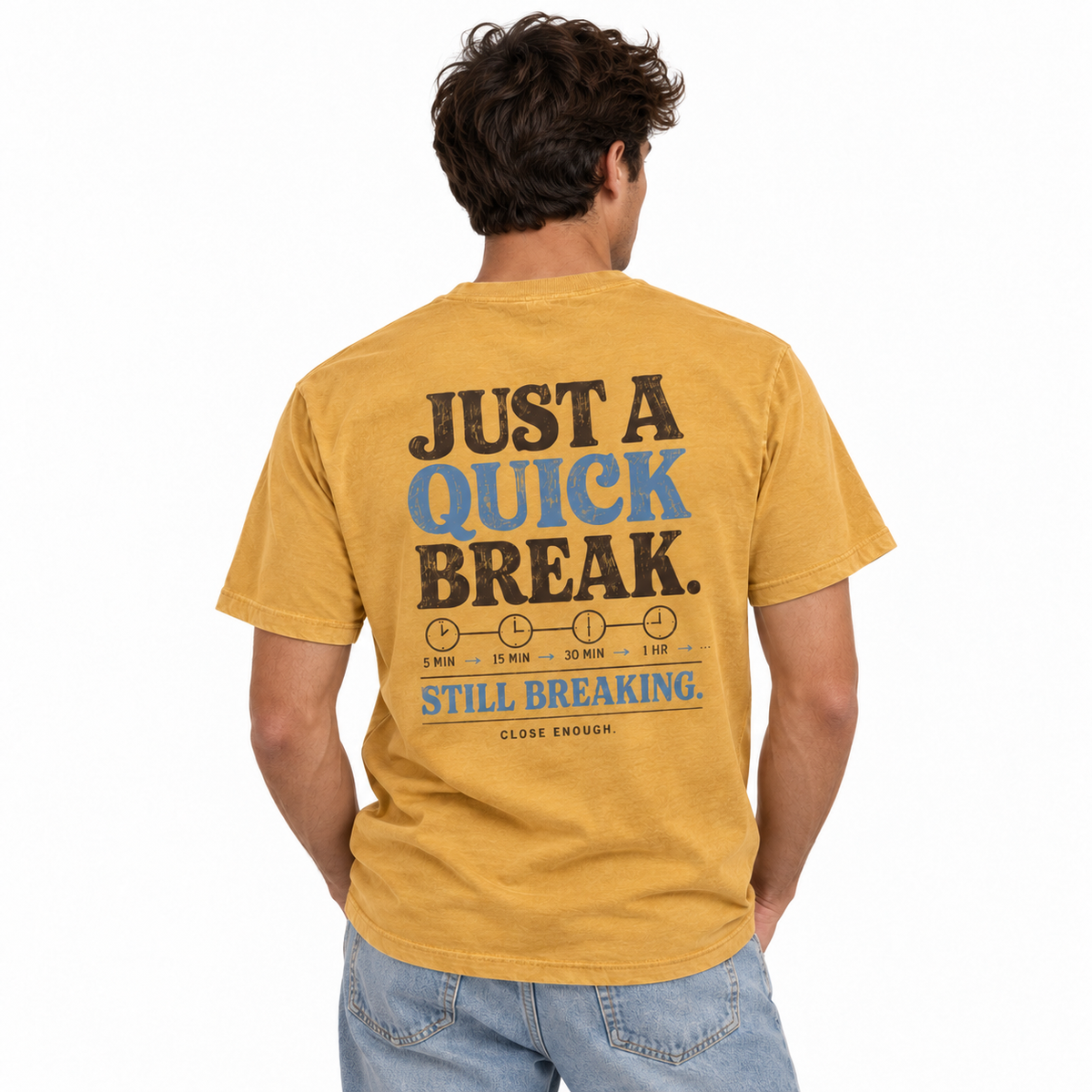 Man wearing the BE RIGHT BACK faded mustard tee showing back artwork