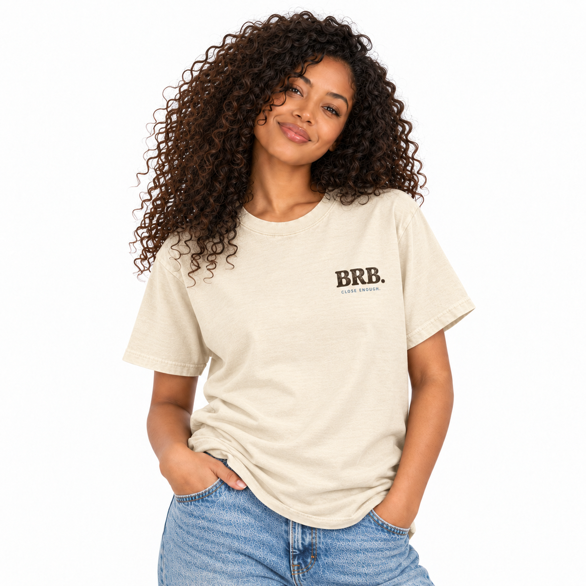 Woman wearing the BE RIGHT BACK cream graphic tee