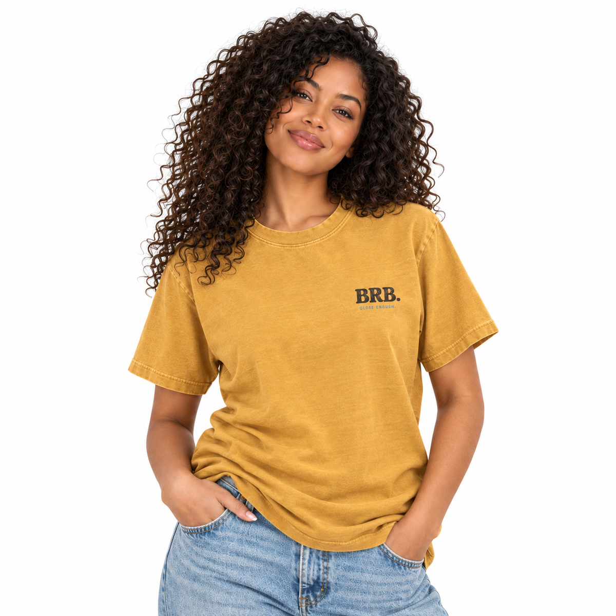 Woman wearing the BE RIGHT BACK faded mustard graphic tee